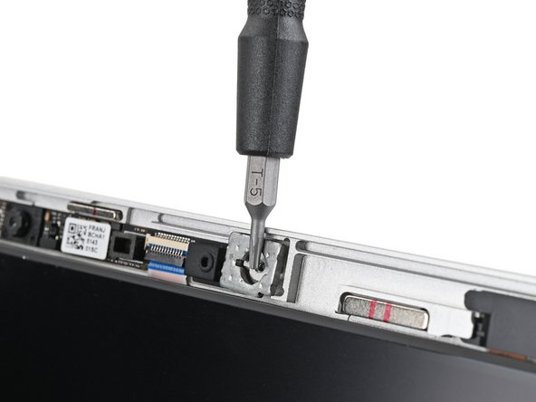 Use the magnetic tip of your Framework Screwdriver to pull the two washers off the Top Cover.