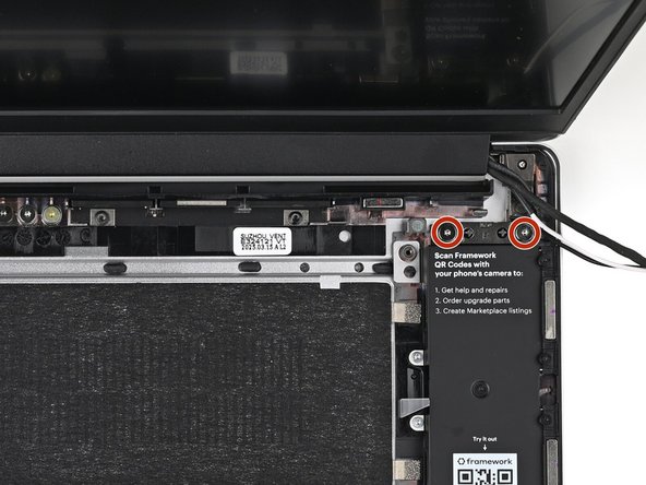 While supporting the Top Cover with one hand, use your Framework Screwdriver to remove two 4.0 mm‑long T5 Torx screws on each Hinge connected to the Bottom Cover (four total).