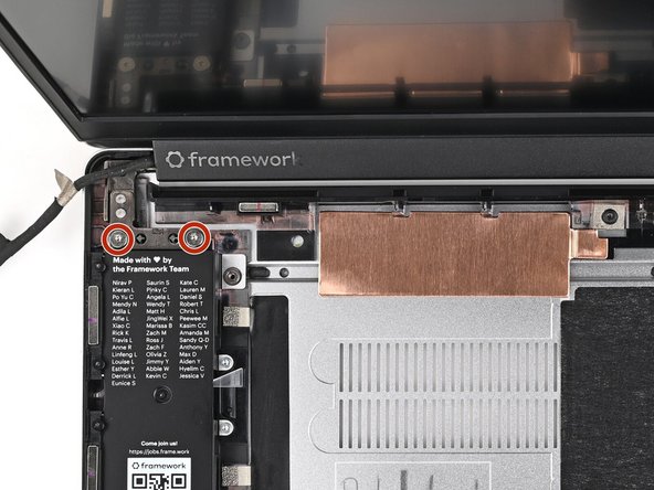 While supporting the Top Cover with one hand, use your Framework Screwdriver to remove two 4.0 mm‑long T5 Torx screws on each Hinge connected to the Bottom Cover (four total).