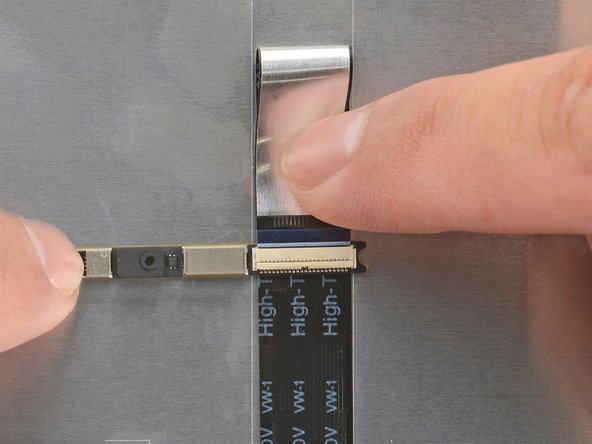 Slide the webcam cable into the ZIF connector up to the printed line on the cable.