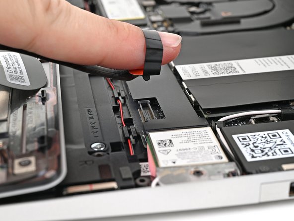 Insert your finger into the Touchpad Cable press connector loop.