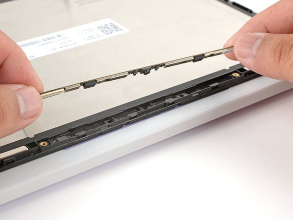 Use your fingers to flip the webcam back into its recess in the Top Cover.