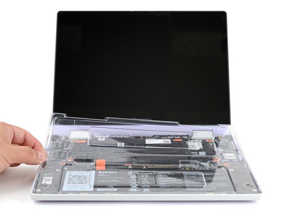 Use your fingers to lift and remove the clear protective cover from the laptop.