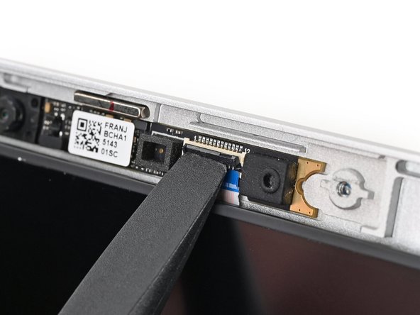 Use the flat end of a spudger, or a clean fingernail, to lift up the locking tab on the webcam ZIF connector.