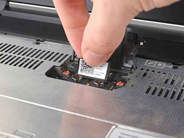 Lift the interposer by its pull tab and remove it.