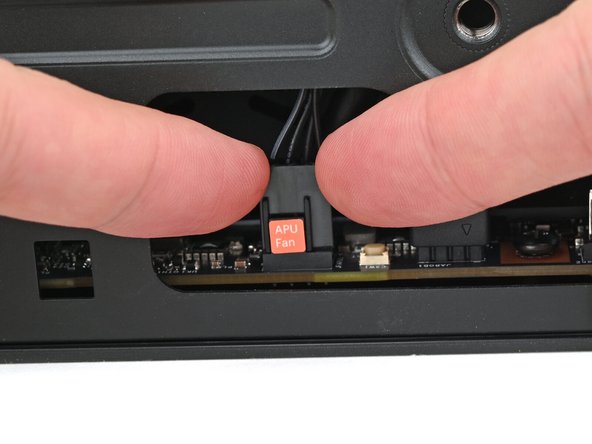 Use your fingers to lift the APU fan cable connector off its four‑pronged socket on the Mainboard.
