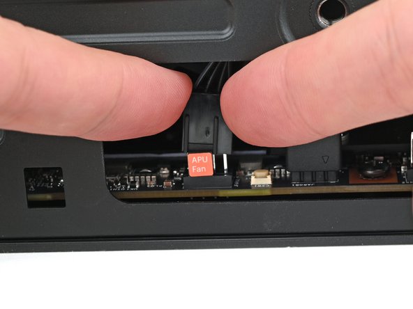 Use your fingers to lift the APU fan cable connector off its four‑pronged socket on the Mainboard.