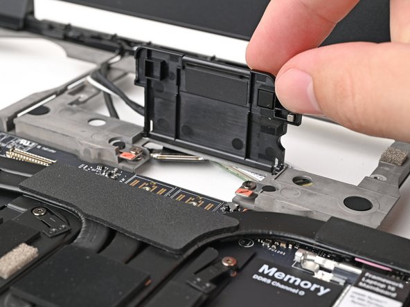 Lift up the interposer door to reveal the screw underneath.