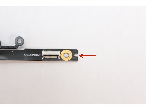 Find the notch on the end of the Fingerprint Reader Module as indicated in the first image.