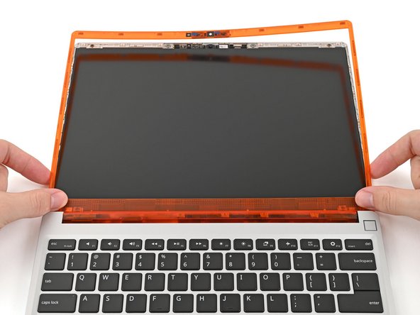 Align the bottom edge of the Bezel with the top edge of the Input Cover and press down so the Bezel covers the hinges and cables.