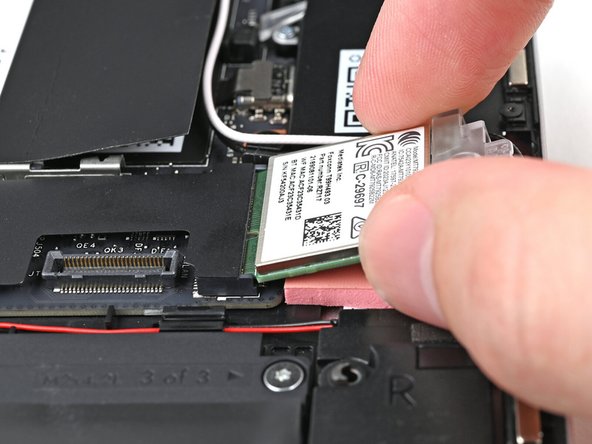 Align the Wi-Fi module's gold contacts and notch with the socket on the Mainboard.