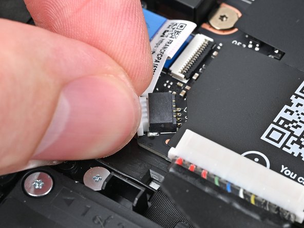 Use your fingers to grip the edges of the speaker cable connector.