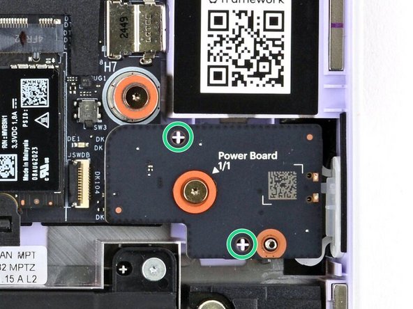 Use the two plastic pins on the laptop to align the Power Button Board.