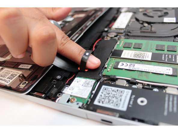 Using slight force, connect the Touchpad Cable by aligning it to the socket on Mainboard. You should hear it click into place once properly connected.
