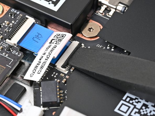 Use the flat end of your Framework Screwdriver, or a clean fingernail, to lift up the locking tab on the Audio Board ZIF connector on the Mainboard.