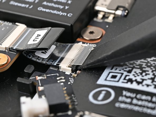 Use the flat end of your Framework Screwdriver, or a clean fingernail, to lift up the locking tab on the Audio Board ZIF connector on the Mainboard.