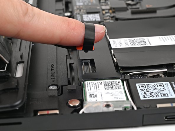 Insert your finger into the Touchpad Cable press connector loop.