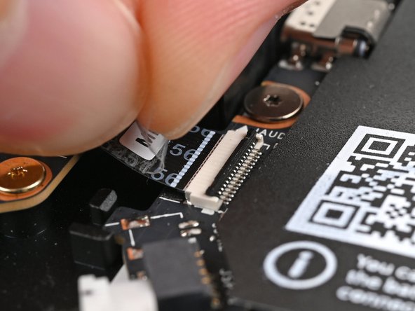 Use your fingers to lightly grip the Audio Board cable and slide it straight out of its socket.