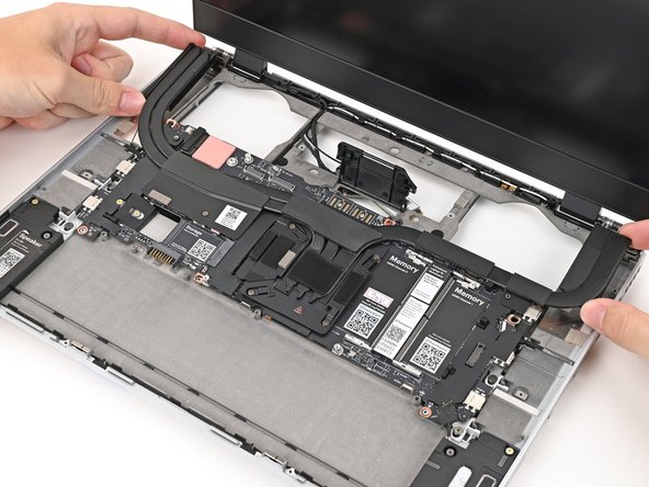 Place the Mainboard into the laptop and onto its alignment pegs.