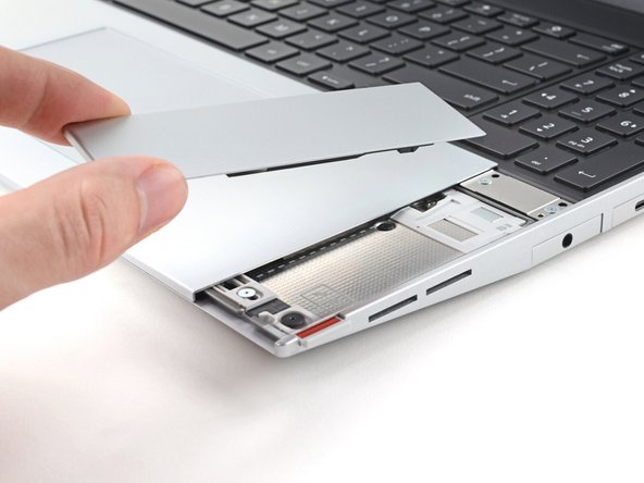 Lift the Touchpad Spacer off the laptop and remove it.