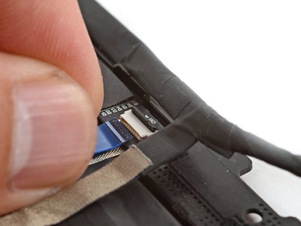 Slide the touch control cable into the ZIF connector up to the printed line on the cable.