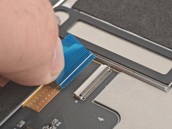 Grab the keyboard cable by the blue tab and slide it out of its connector.