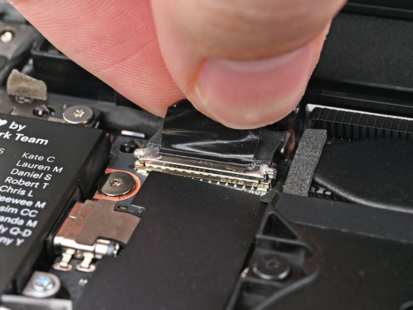 Grip the eDP Cable connector by its pull tab and lift up to disconnect it.