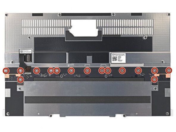 Use your Framework Screwdriver to install the fifteen 1.4 mm‑long screws securing the Input Module Connector Board.