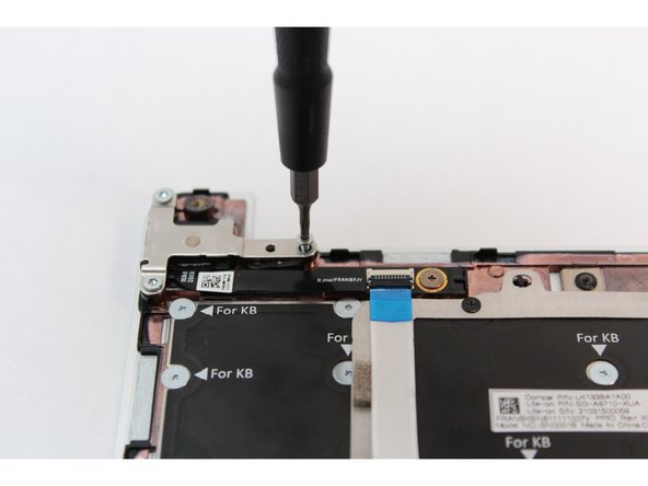 Gently lift the silver bracket off the module and move it away.