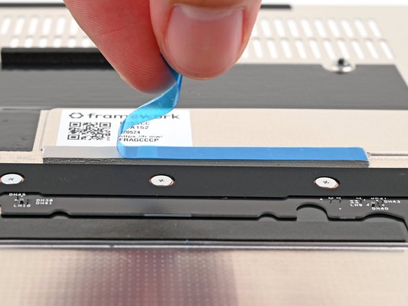 If there's a blue liner on the thermal pad located on the bottom of the Mid Plate, use your fingers to peel it off.
