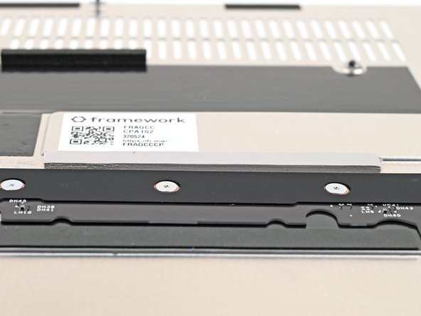 If there's a blue liner on the thermal pad located on the bottom of the Mid Plate, use your fingers to peel it off.