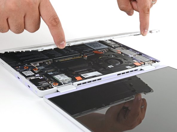 Lift upwards to swing the Input Cover up from the base of the laptop.