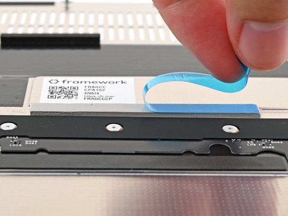 If there's a blue liner on the thermal pad located on the bottom of the Mid Plate, use your fingers to peel it off.