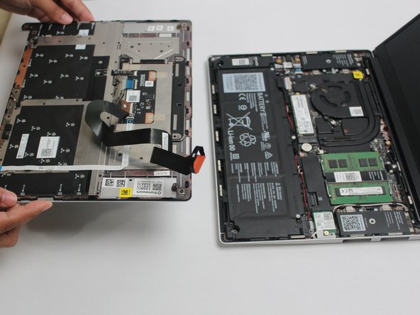 Once the Touchpad Cable is disconnected, remove the Input Cover away from the Mainboard.