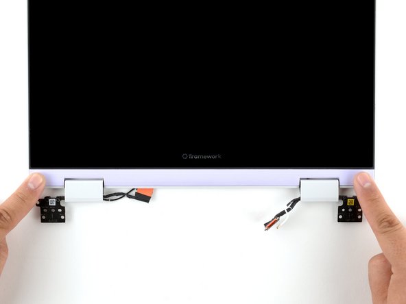 Use your finger to press along the length of the Display Cover to snap it onto the laptop.