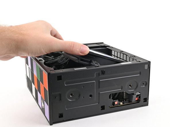 Lift the fan out of the chassis, making sure the cables thread through the side of the heatsink.