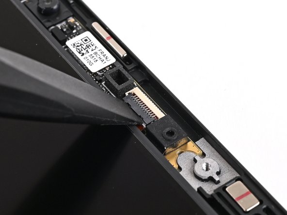 Use the flat end of your Framework Screwdriver, or a clean fingernail, to lift up the locking tab on the Webcam ZIF connector.