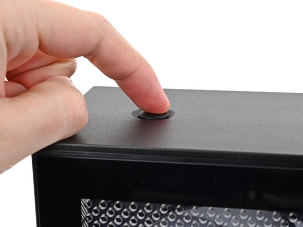 Use your finger to lift up the two D-rings on the Top Panel screws.