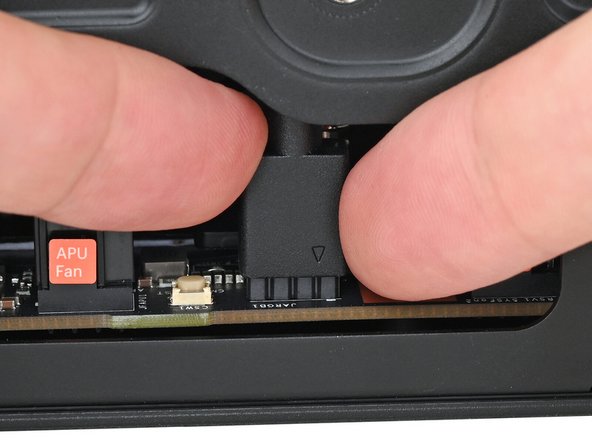 Use your fingers to slide the RGB cable over the three pronged connector located to the right of the &quot;APU Fan&quot; connector.