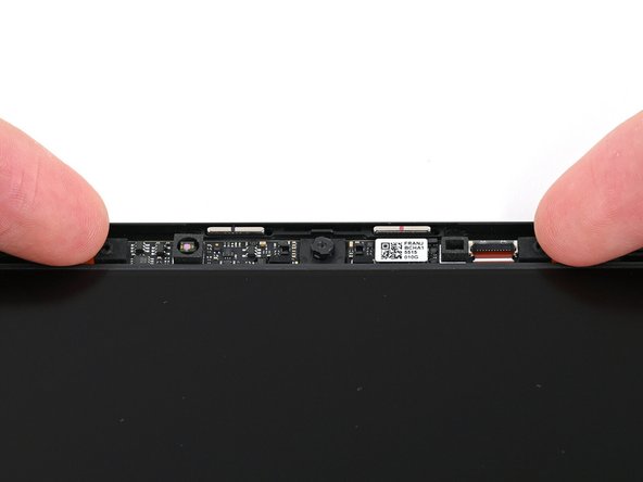 Grip the edges of the Webcam and lift it straight up so its cable slides out of the ZIF connector.