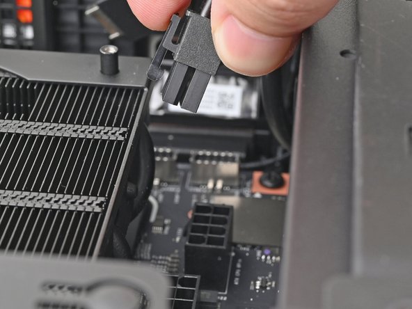 While squeezing the clip on the CPU power cable, pull it straight up and out of its socket to disconnect it.