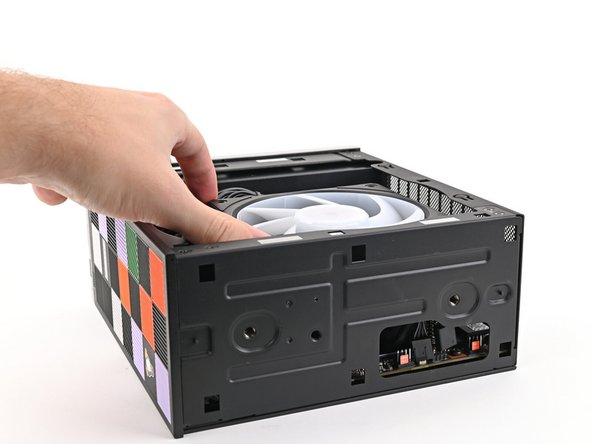 Lift the fan out of the chassis, making sure the cables thread through the side of the heatsink.