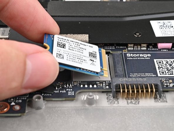Avoid touching the gold contacts. Only press on the top label or the edges of the SSD.