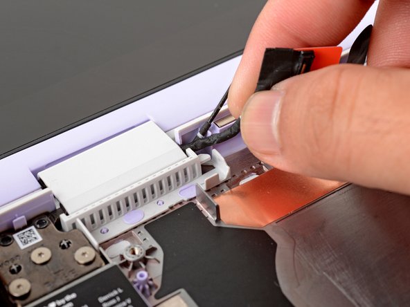 Use your fingers to gently press the webcam cable into its plastic channel.