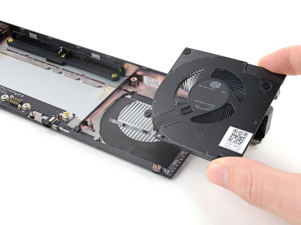 Use your other hand to pull the fan out of its housing, making sure to thread the cable through its slot.