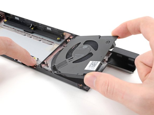 Use your other hand to pull the fan out of its housing, making sure to thread the cable through its slot.