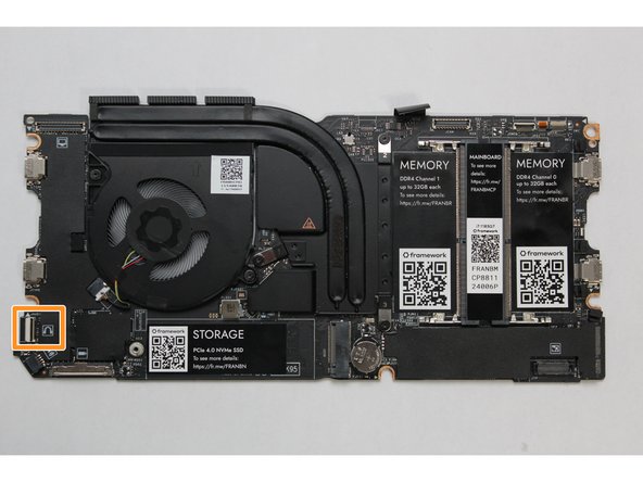 Connect the Audio Board cable by gently sliding it into the Mainboard. Make sure the black latch on the connector is flipped up so that you can slide the Audio Board Cable into the connector. Slide the cable straight in until the white line is almost at the edge of the connector