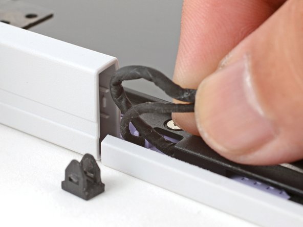 Pull gently to pop out the black cable clip and release the cables.