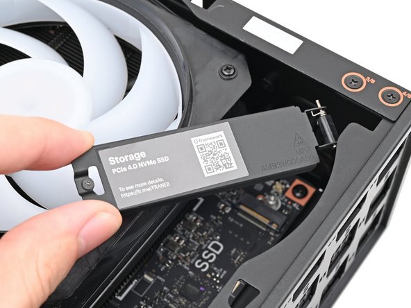 Lift the primary storage heat spreader out of the Desktop and remove it.