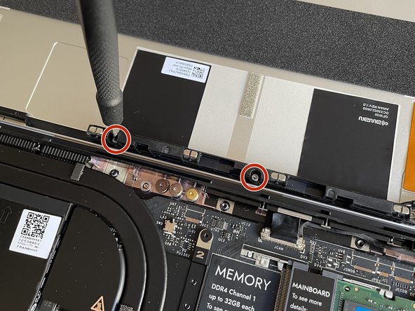 Using the T5 bit in the Framework Screwdriver, remove the two fasteners that are holding the Antenna Module into the Top Cover.